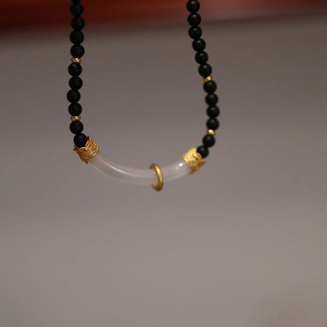 Women's Chinese style necklace with matte black agate pendant and silver ball bead chain.