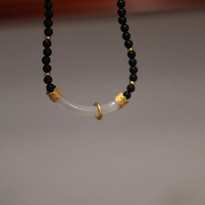 Women's Chinese style necklace with matte black agate pendant and silver ball bead chain.