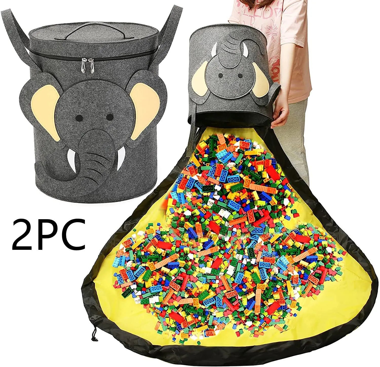Green felt storage cube with pull rope unfolded into a large square play mat on a wooden floor.