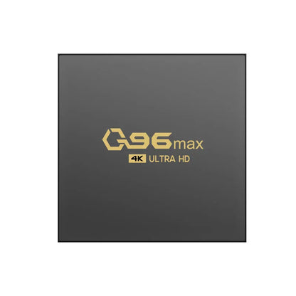Q96 MAX Android TV set-top box with remote control and HDMI cable on a wooden surface.