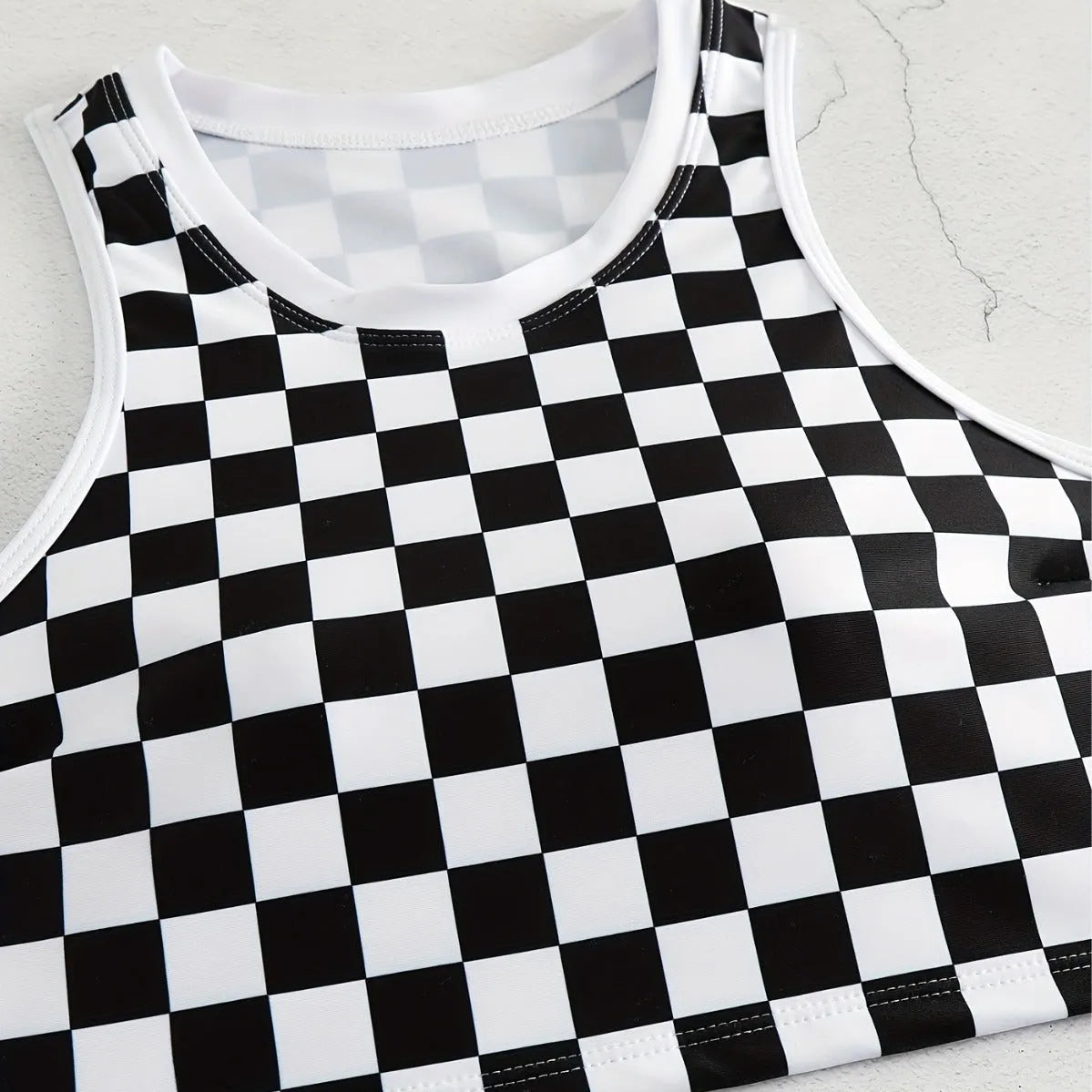 Women's black and white checkerboard print backless racing swimsuit with suspender straps