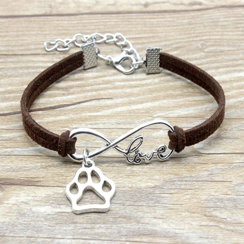 Hand-woven Infinite Love Pet Bracelet in various colors, showcasing the bow shape and alloy material.