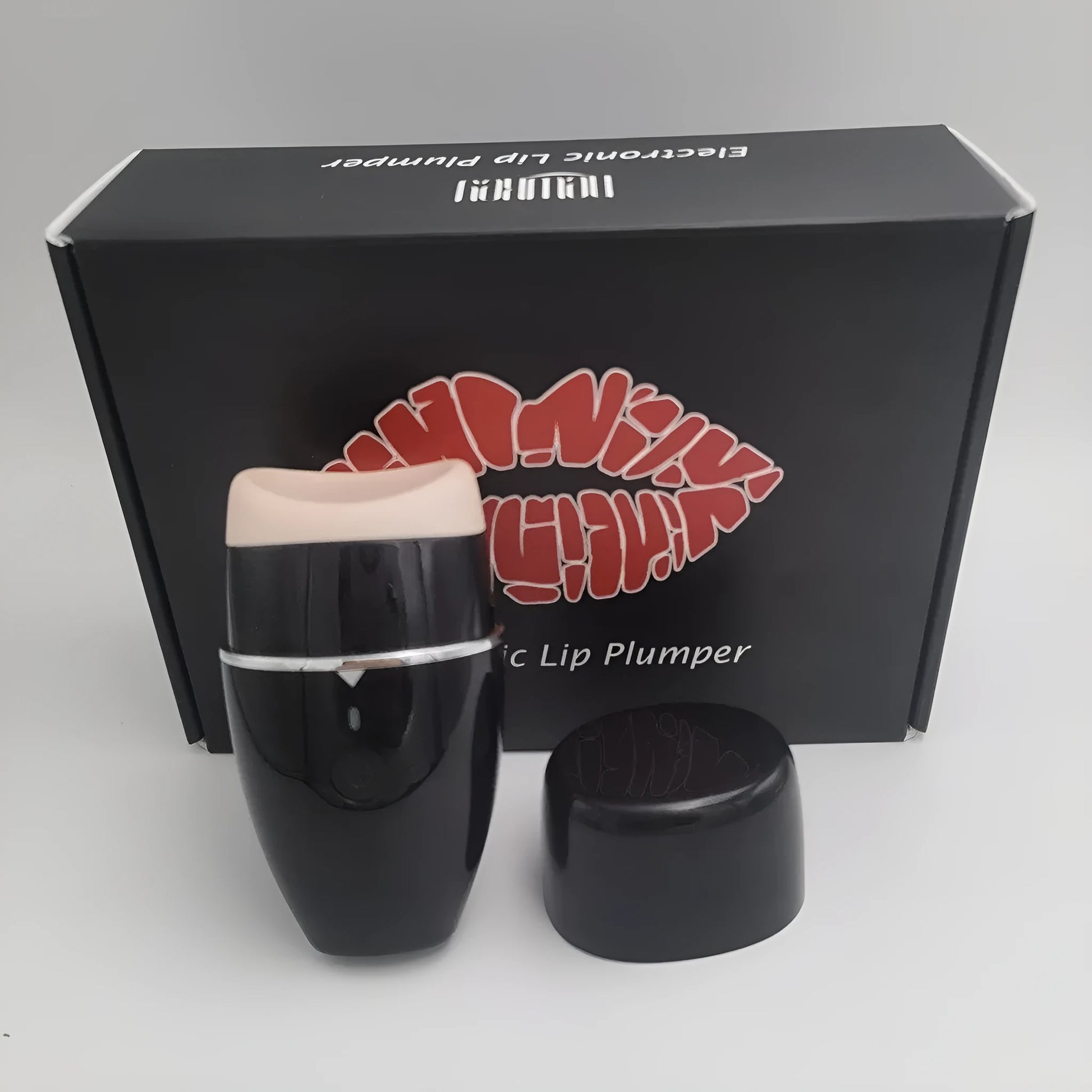 Black and white electric lip plumper device with silicone tip and USB cable