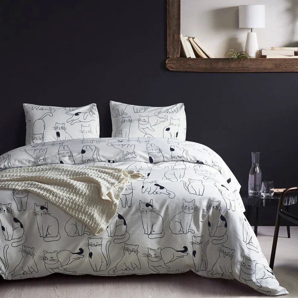 White cotton bedding set with active printed pattern, showing duvet cover, fitted sheet and pillowcases