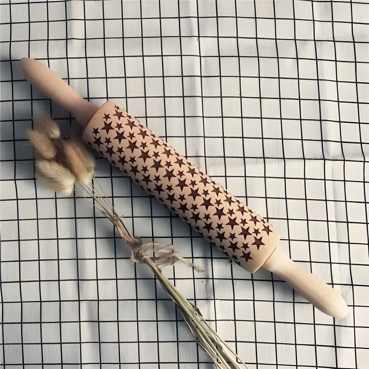Wooden rolling pin with engraved Christmas patterns including reindeer and snowflakes on a 45cm long barrel.