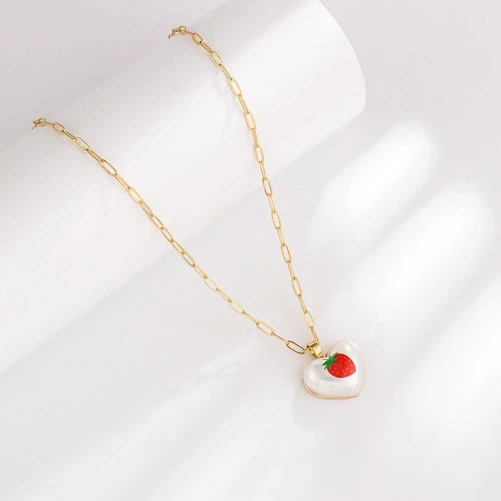 Geometric heart-shaped fruit pendant necklace on an adjustable metal chain
