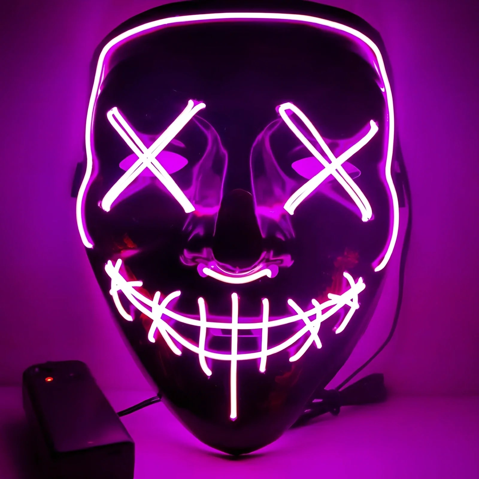 Black V-shaped electroluminescent Halloween mask glowing with uniform illumination, showing folding capability and plastic construction