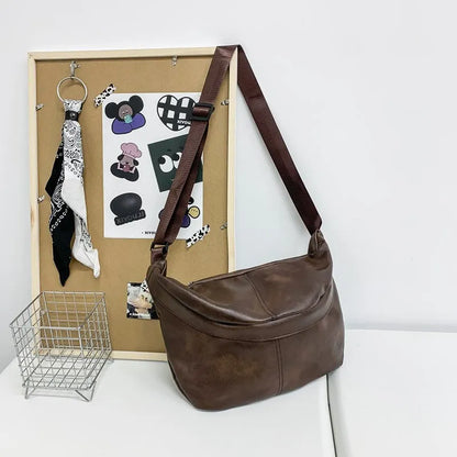 Retro style brown men's crossbody messenger bag showing storage compartments and 50cm width dimensions