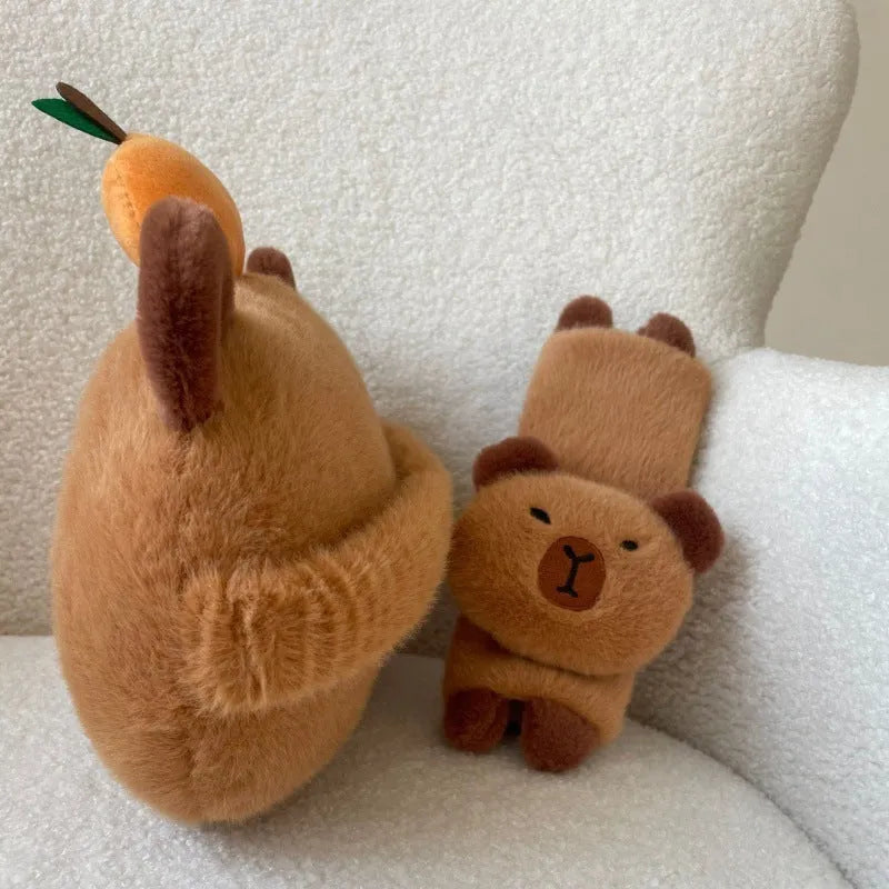 Khaki capybara car pillow in artificial plush with synthetic fibre filling, shown as a car neck pillow or shoulder cover.