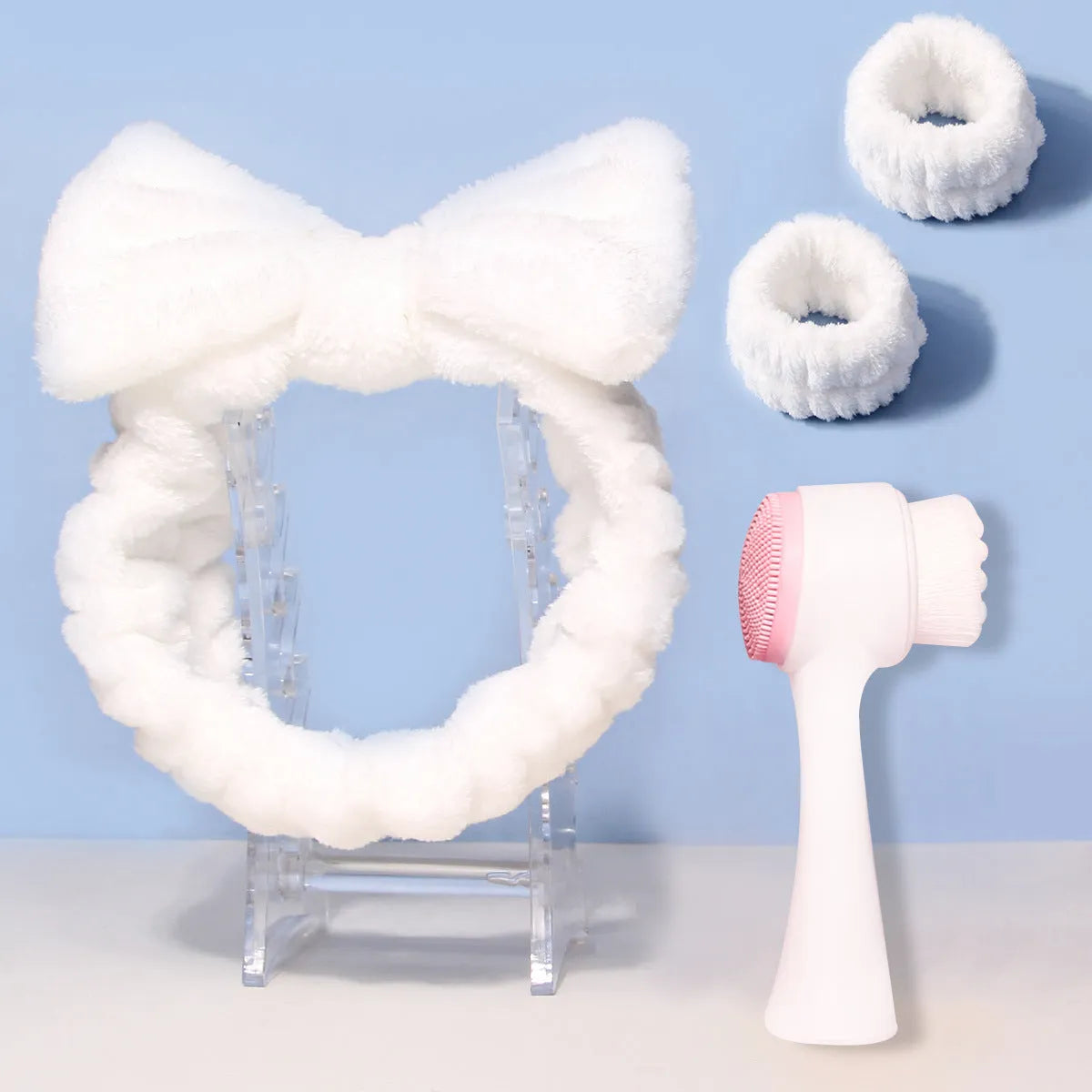 Facial brush set with coral fleece hair band and 4-count nylon brush heads in purple, gray, white, pink colours