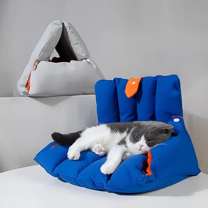Blue triangular cotton cat bed with a removable cover on a wooden floor.