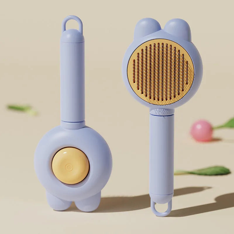 Green self-cleaning pet grooming brush with a release button and rubber-tipped metal pins on a non-slip handle.