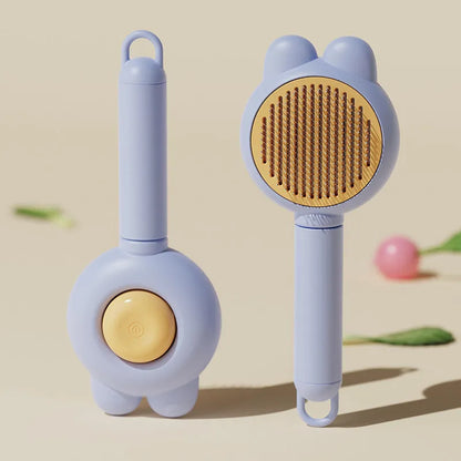 Green self-cleaning pet grooming brush with a release button and rubber-tipped metal pins on a non-slip handle.