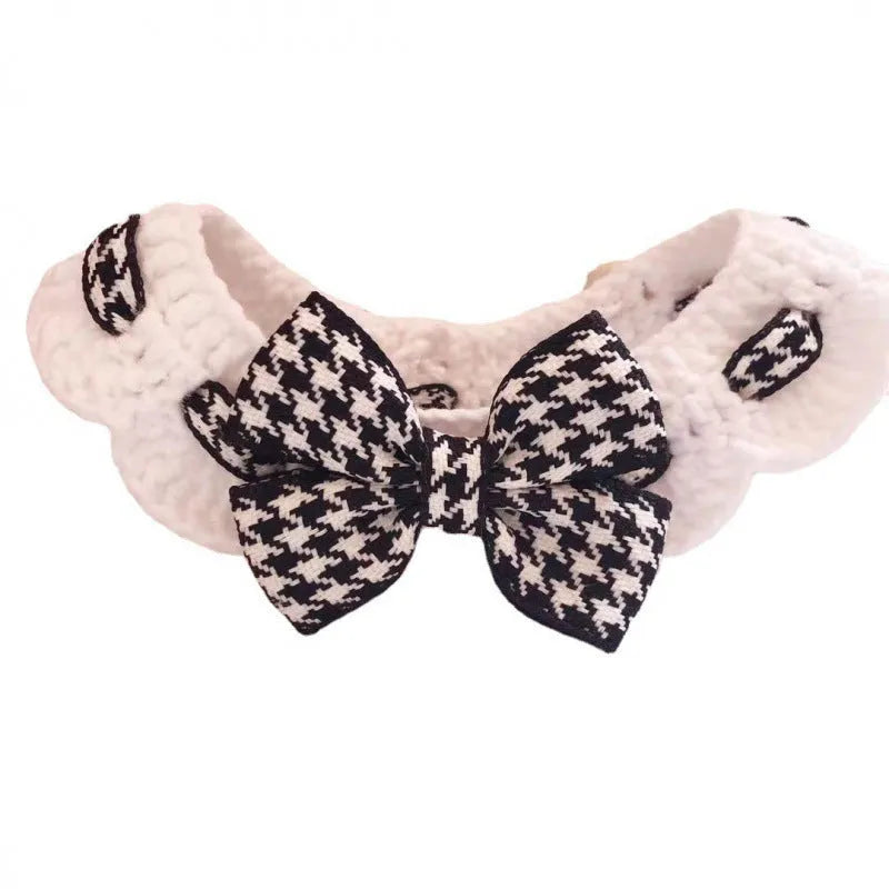 Red and black houndstooth check knitted dog collar showing wool texture, laid flat with size tag.