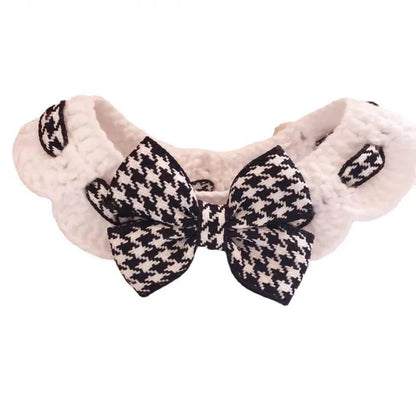 Red and black houndstooth check knitted dog collar showing wool texture, laid flat with size tag.