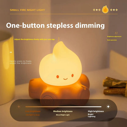 Small silicone fire pile-shaped night lamp with a cartoon ABS shade showing yellow light illumination.