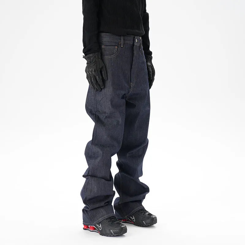 Man wearing dark blue loose-fit straight-leg denim jeans, showcasing the casual relaxed silhouette.