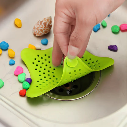 Three starfish-shaped sink drain filters in white, blue and green colours showing suction cups on bottom