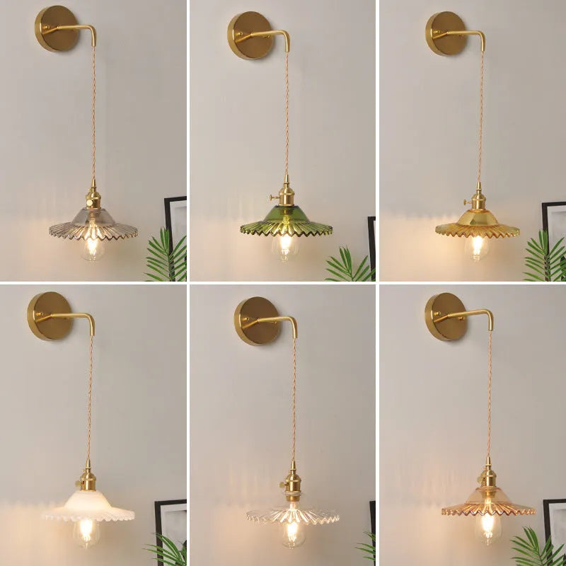 Retro brass lotus wall lamp with copper body and glass shade in various colours, mounted on a wall