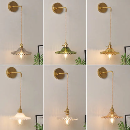 Retro brass lotus wall lamp with copper body and glass shade in various colours, mounted on a wall