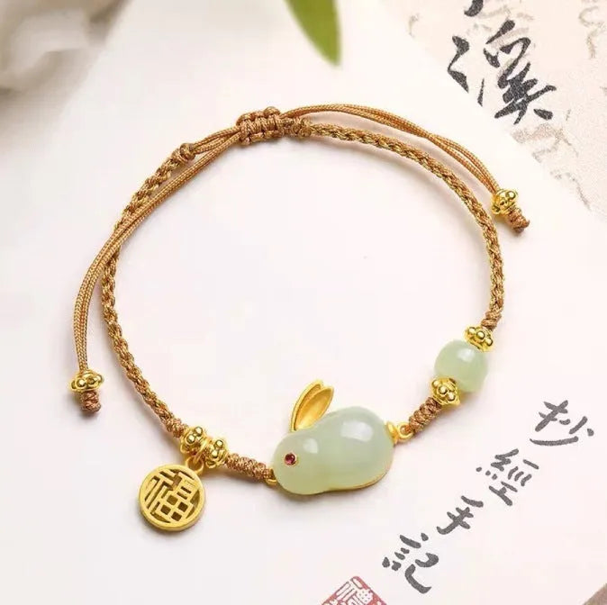 Hetian jade geometric rabbit charm on a yellow string bracelet for women.