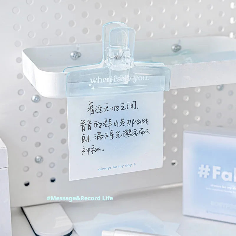 Square gradient-cover notepad showing pastel colours, open to reveal sticky notes, plain paper, and parchment sheets.