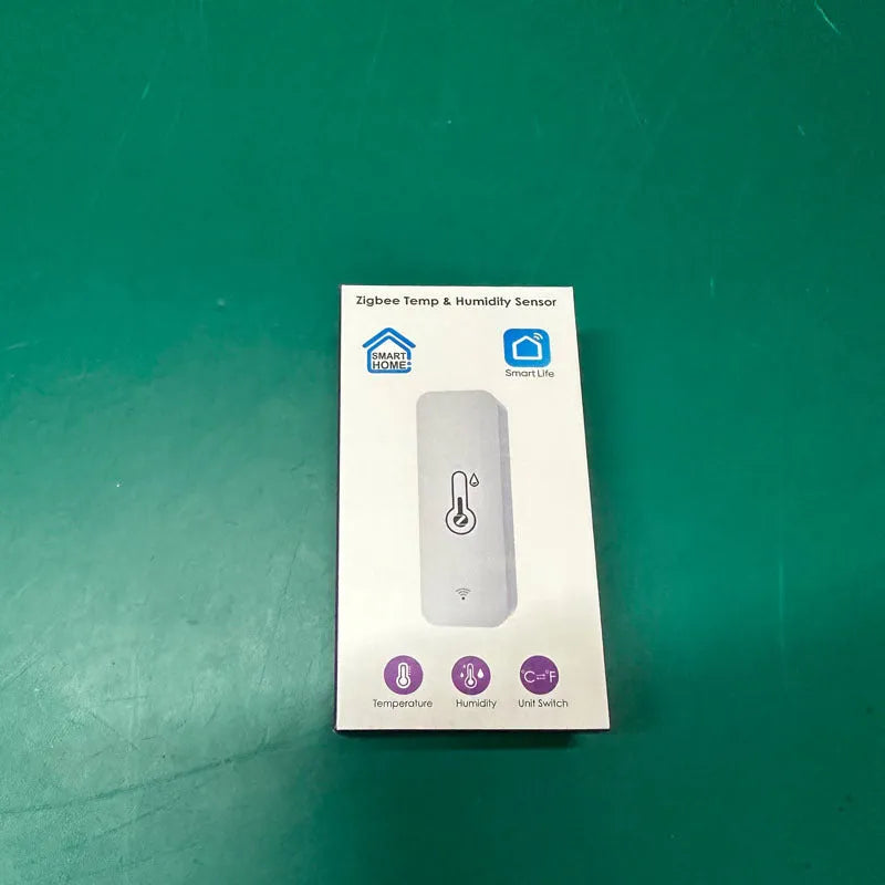 Compact white WiFi temperature and humidity sensor for smart home monitoring.