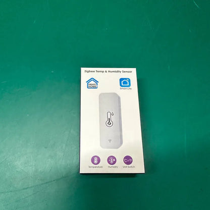Compact white WiFi temperature and humidity sensor for smart home monitoring.
