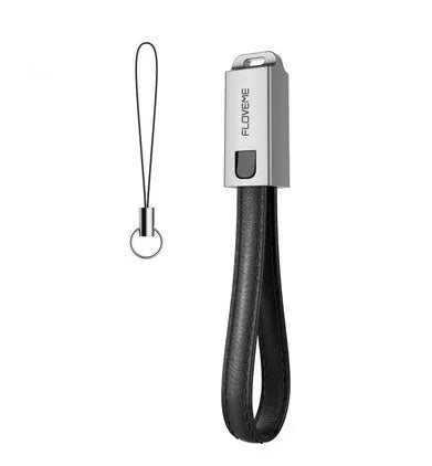 Short black leather iPhone charging cable with metal connector next to a power bank