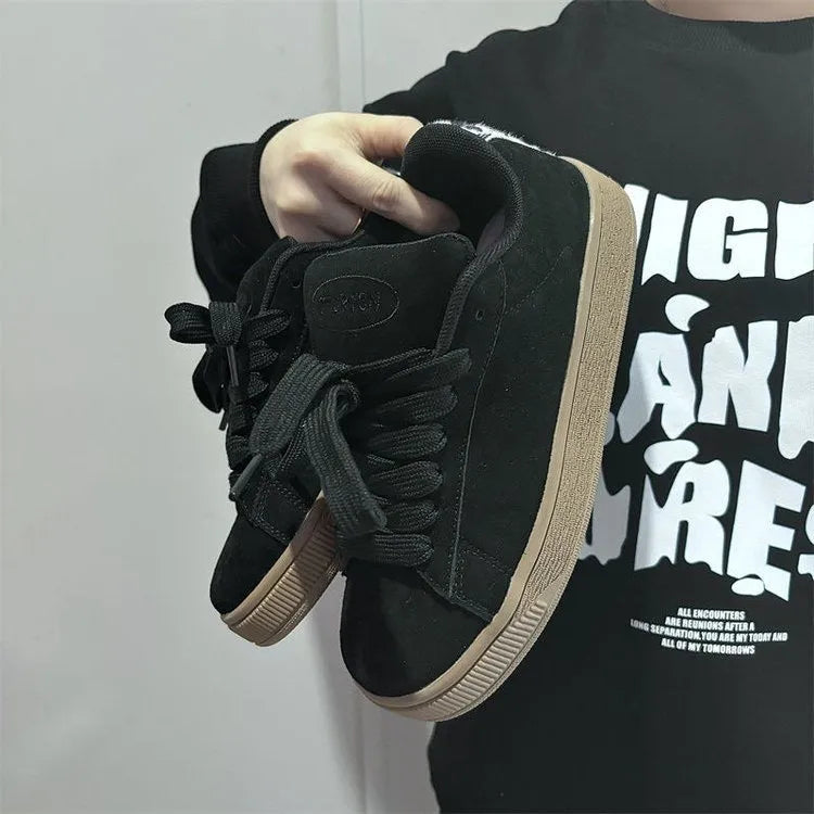 Black retro low-top sneakers with round toe, lace-up front, and a waterproof platform sole.