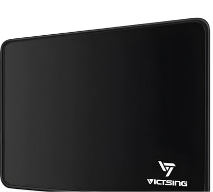 Large black thickened rubber mouse pad with a rough grain texture on a desk.