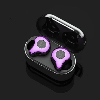 Coffee-coloured true wireless Bluetooth earbuds sitting in an open charging case on a wooden table.