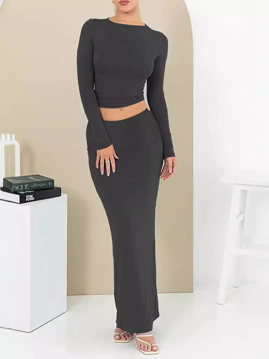 Women's black polyester two-piece suit with a sweet style, featuring a top and long skirt in a slim fit.
