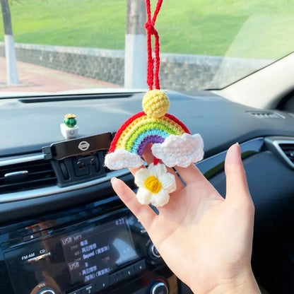 Handmade crocheted cartoon-style car pendant in wool, shown in avocado, pink rainbow, and red rainbow colour options.
