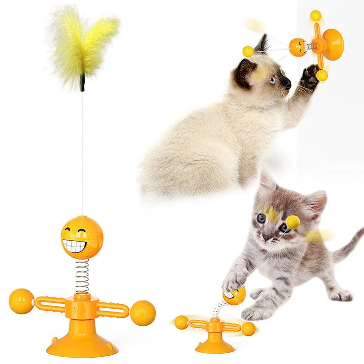 Cat playing with rotating windmill toy featuring suction base and luminous ball