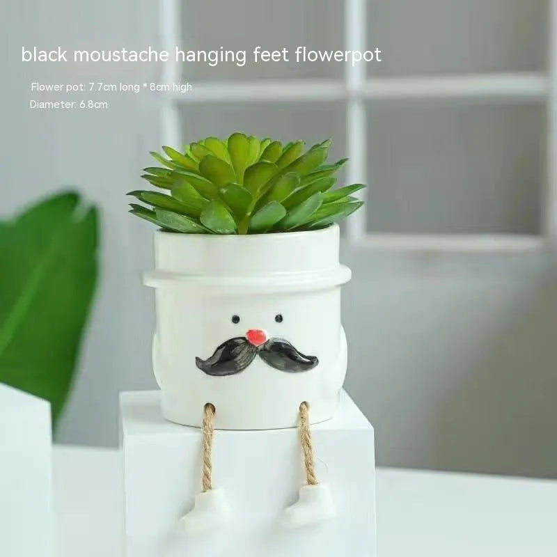 Ceramic hanging foot flowerpot for succulent plants with cartoon styling on desktop