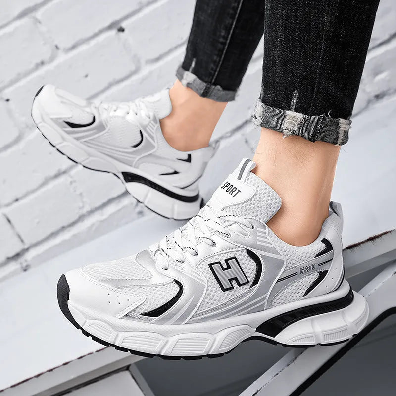 Men's white and grey mesh running shoes with round toe and plastic sole.