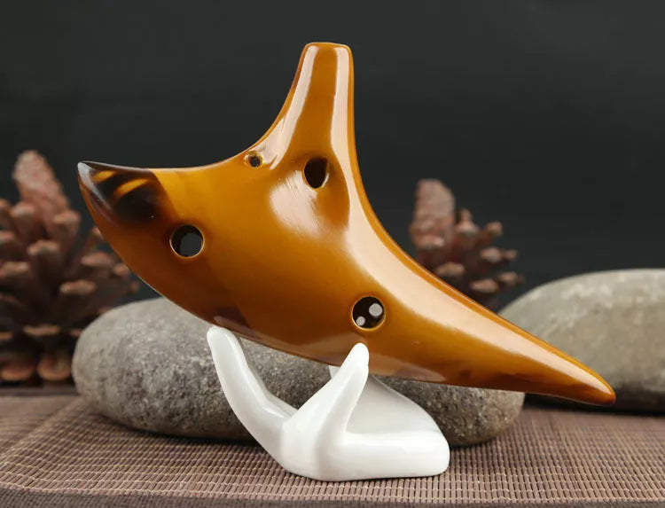 Ceramic 12-hole smoldering ocarina in alto C pitch with nest-inspired design