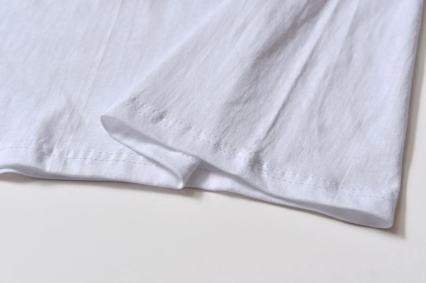 White cotton pullover overalls with a pattern, short sleeves, and a round neck on a teenager.