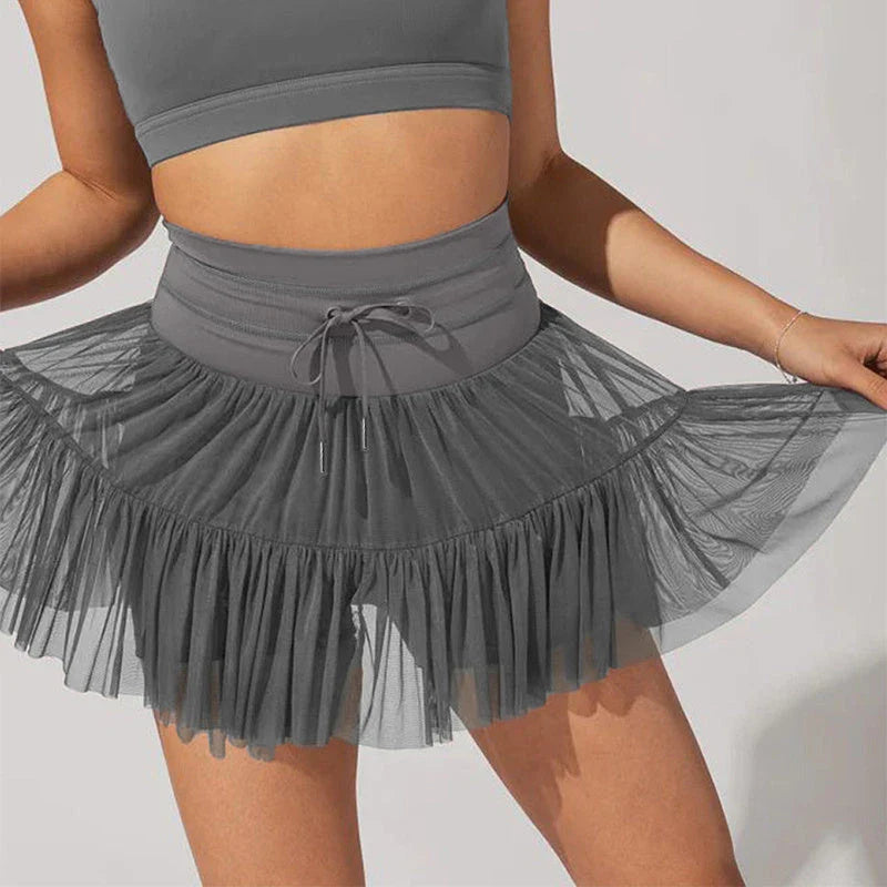 Stylish high-waist pleated mini skirt with lace-up design and built-in anti-exposure safety shorts, available in a variety of vibrant colors.