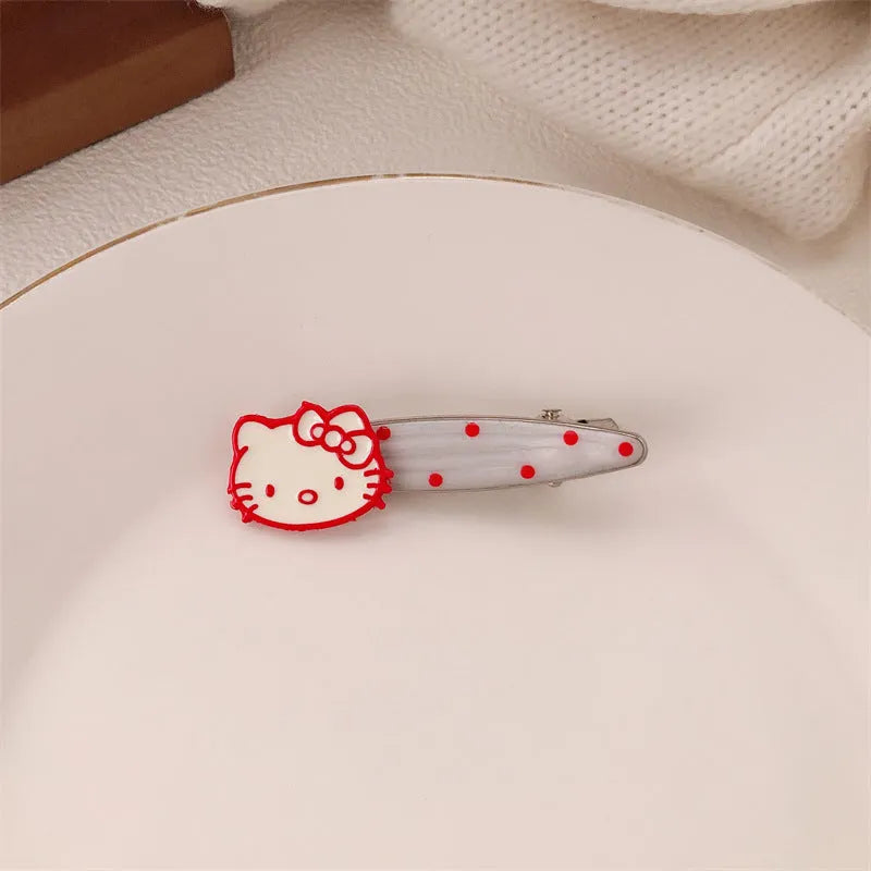 Red plastic hair clip with a 3D love heart and dots on a willow leaf-shaped base.