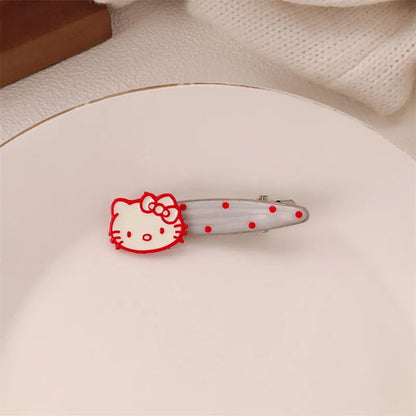 Red plastic hair clip with a 3D love heart and dots on a willow leaf-shaped base.