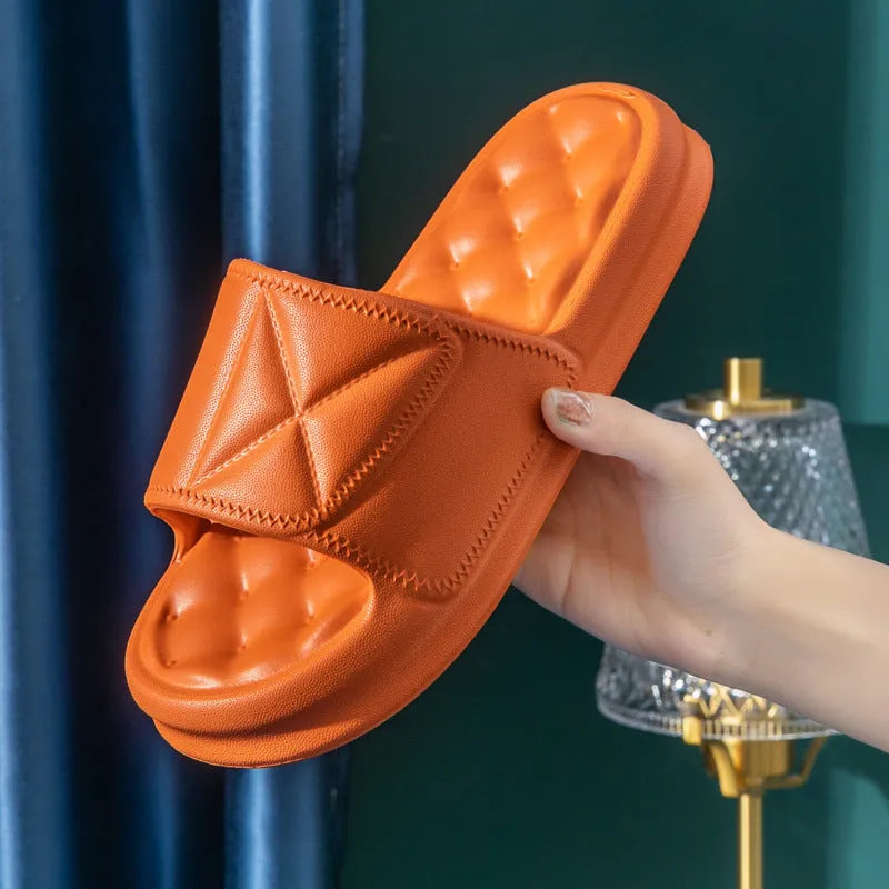A pair of thick-soled EVA bathroom slippers in a selected colour, showing their injection-moulded non-slip design.