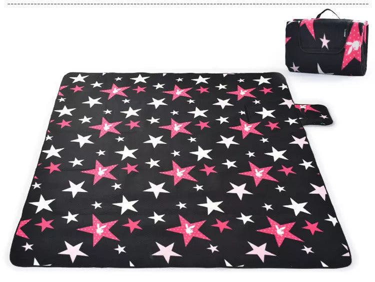 Folding Suede Picnic Moisture-proof Mat in blue stripes, unfolded on grass