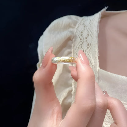 Open mouth silver and gold ring with J14 Xiangyun geometric pattern on a white copper band.