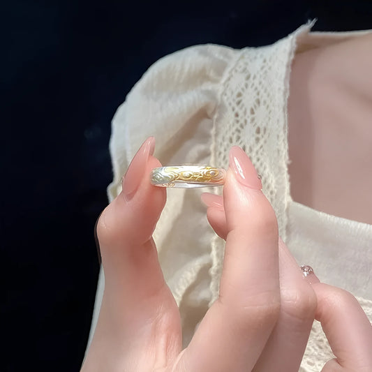 Open mouth silver and gold ring with J14 Xiangyun geometric pattern on a white copper band.