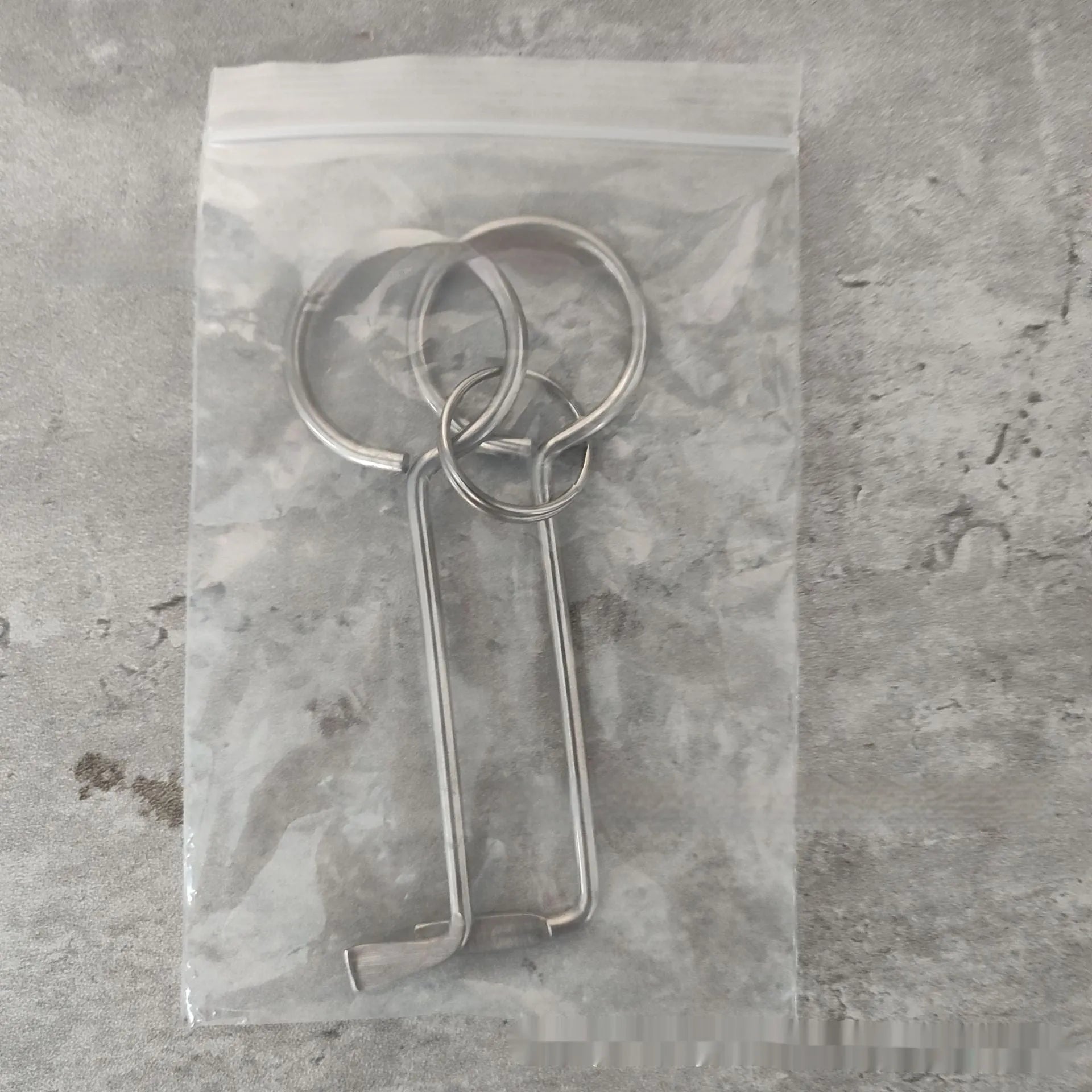 Two silver alloy wrench tools from a portable universal family set on a plain background.