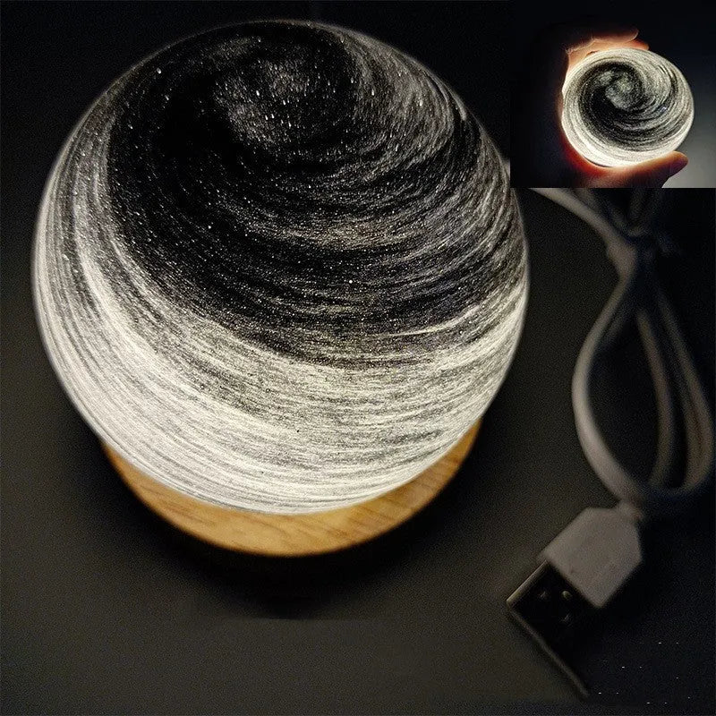 Planet-shaped USB night light with adjustable dimming in 12 colour options on its base.