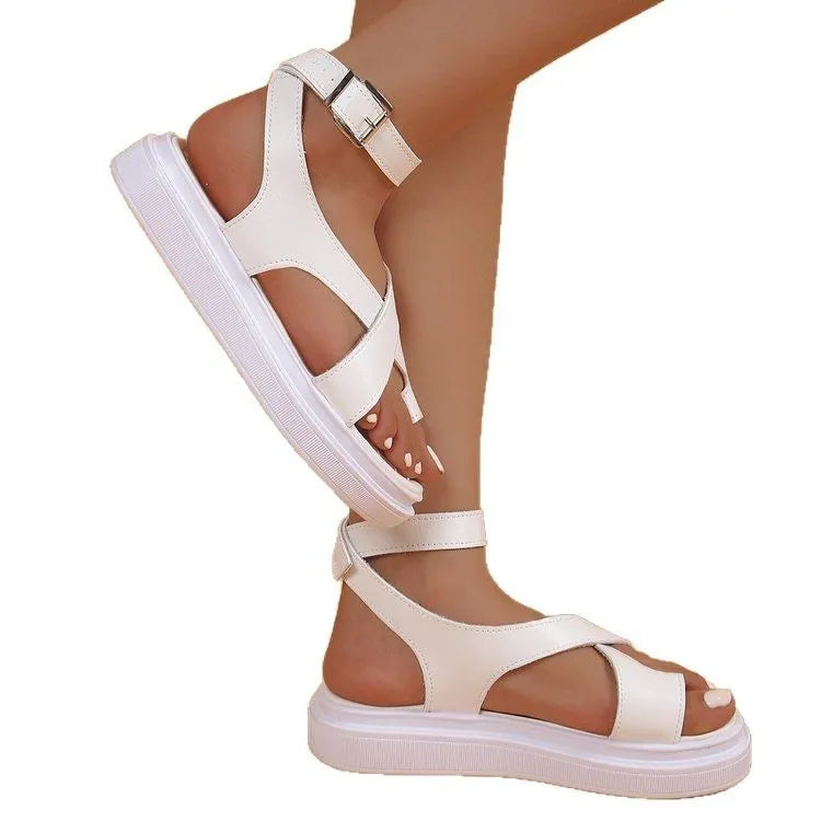 Women's white Roman-style sandals with thick composite sole, outer lace loops, and adjustable buckle fastening