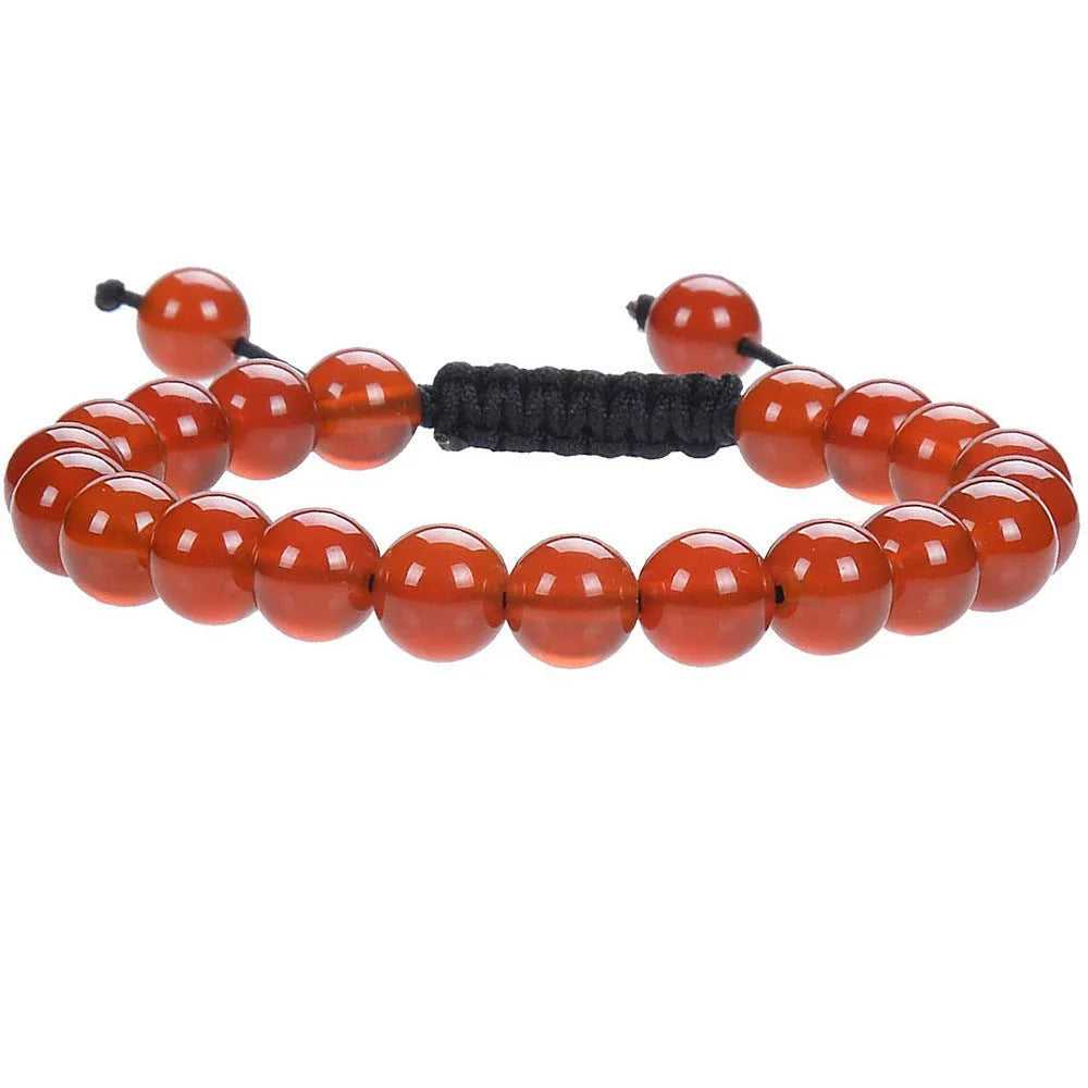 Close-up of a women's flat knot braided healing bracelet hand-woven with colourful gemstones.